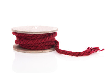 Red rope on wooden roll