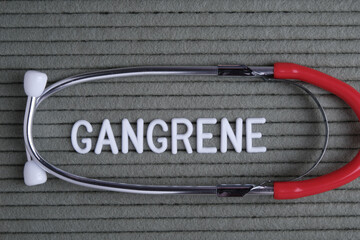 gangrene - text from white letters on  green background with  stethoscope, medical concept...