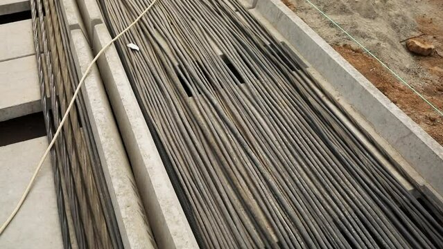 Laying of high voltage power cables into concrete duct. Underground electrical installation for building station. Electrical equipment close view