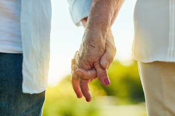 Hold my hand and lets make it last. Cropped shot of a senior couple holding hands in a park.