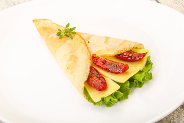 Pancake with cheese and dry tomato