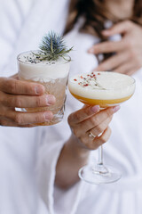 Cocktails in a glass in human hands 