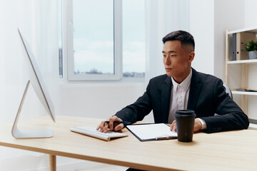 man works at the computer glass of coffee emotion office technologies