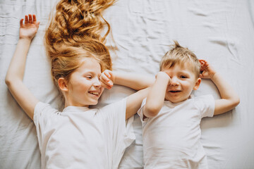 Brother and sister together lying in bed