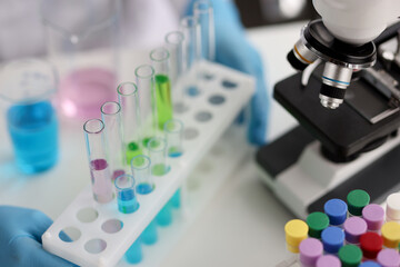 Fototapeta premium Multicolored laboratory test tubes and microscope in laboratory