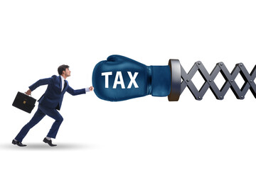 Tax concept with businessman being hit by boxing glove