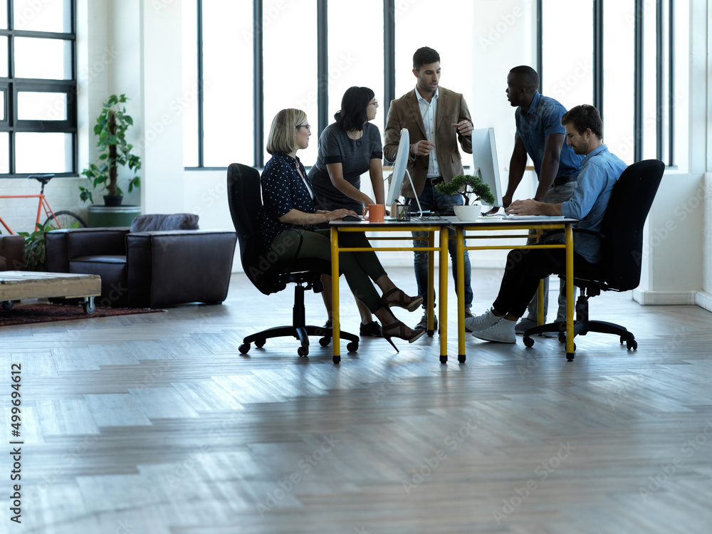 Aufkleber allow me to explain.... full length shot of a group of businesspeople gathered around a table in the