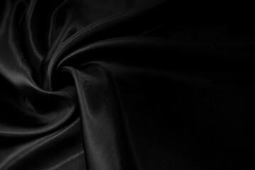 Part of the dark fabric texture of the fabric for the background and decoration of the work of art, a beautiful crumpled pattern of silk or linen. A crumpled piece of cloth