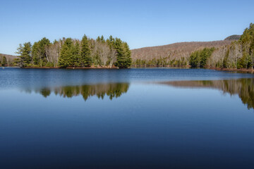 Fototapeta na wymiar In spring, beautiful lake in the Canadian in the province of Quebec