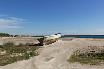 single old fishing boat on the summer empty beach black sea coast 