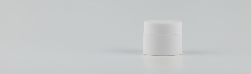 Unbranded white plastic jar for cosmetics products. Skincare and cosmetology banner mockup. Branding identity template for text and design