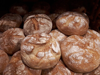 Loaves of round bread lie on a shelf in a store