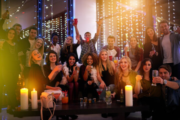 The night is young, and so are we. Shot of a large group of young people enjoying themselves at a nightclub.