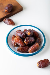 Fresh red dates (hurma) in a bowl