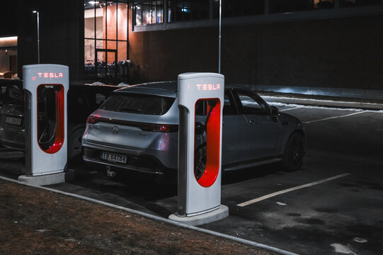 Sandefjord, Norway - februar 25, 2022: Silver Mercedes EQC Parked At Tesla Supercharger Station. The Mercedes EQC Is A Full-sized All-electric Five-door SUV