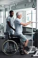 Full length portrait of senior man doing rehabilitation exercises in gym at medical clinic with therapist assisting - obrazy, fototapety, plakaty