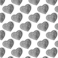 Seamless pattern with stone hearts on white.