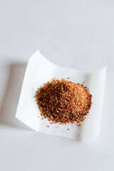 Chilli flakes and herbs on paper