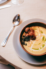 Spinach soup with cream in a bowl. Close up.