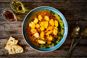 Fish soup on wooden table
