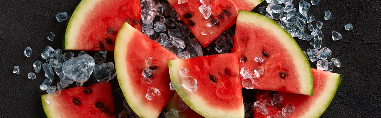 Flat lay top view watermelon with ice on black background. Sliced fruit with seeds