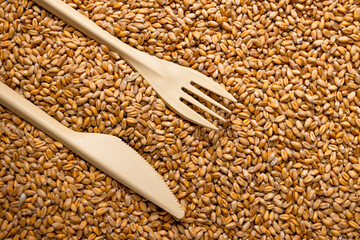 Plastic folk, knife and wheat grain . Export ban, embargo on wheat and flour supplies to Europe , Asia and Africa, famine and crisis