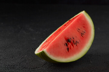 Fototapeta na wymiar Watermelon on black background. Sliced fruit with seeds