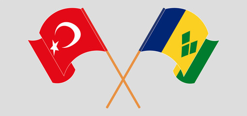 Crossed and waving flags of Turkey and Saint Vincent and the Grenadines