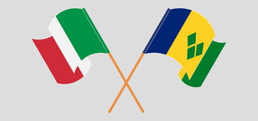 Crossed and waving flags of Italy and Saint Vincent and the Grenadines