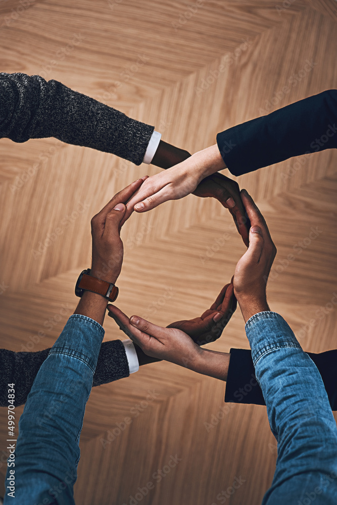Aufkleber There is more power in unity than division. High angle shot of a group of unidentifiable businesspeople forming a circle with their hands.