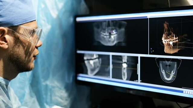 A dentist examines a 3D panoramic image of the jaw on the screen. MRI diagnostic equipment for teeth in a modern dental clinic.