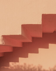 Obraz premium A photo of stairs in minimal boho style. Painted plaster texture. Summer shadows on the wall.