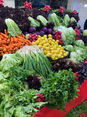 Fresh vegetables and herbs on the on display in market. Healthy and organic food concept