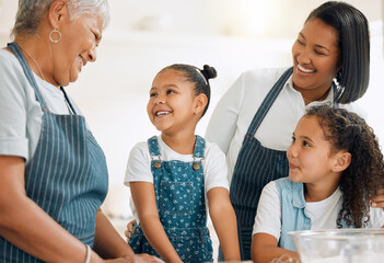Grandma is teaching us her special recipe. Shot of a multi-generational family baking together at...