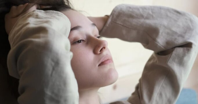 Nervous young woman feeling stress, regretting a mistake, emotions of despair and pain, suffering from psychological problem. She grabs her head, feels frustration and depression after wrong choice.