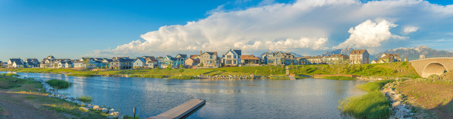 Daybreak residential community near the bridge over the Oquirrh lake with dock at the front