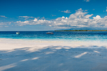 Sandy beach and blue ocean in paradise island. Holiday beach with white sand and sea water