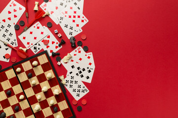 Different board games on color background, top view