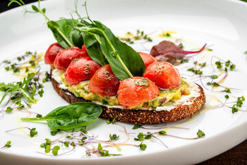 Delicious bruschetta with cream cheese, gluacomoli sauce and cherry tomatoes