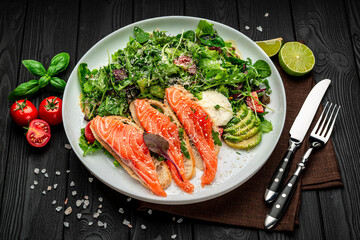 Salted salmon on croutons with fresh salad and parmesan cheese
