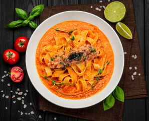 Pasta with salmon tartare and tomato sauce, Italian Food.