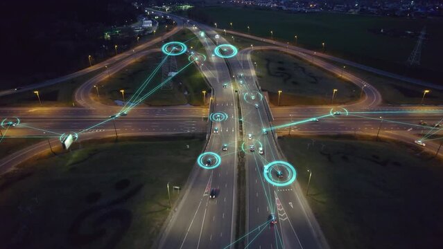 Autonomous self-driving mode vehicles on night highway road junction. Aerial view of smart cars with automatic sensor driving on highway with wireless connection.