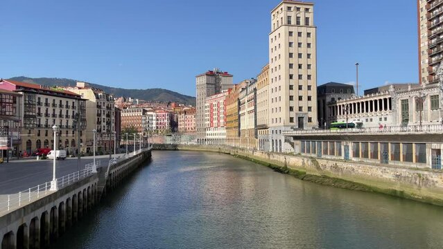Nervion river and buildings from Arenal bridge on sunny day in Bilbao city