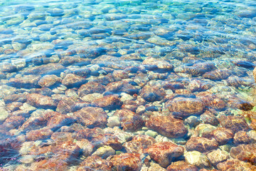 Tropical transparent water with stones on the bottom