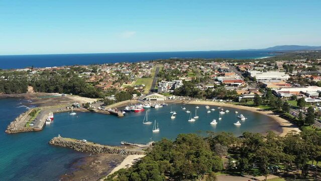 Aerial flying down to Ulladulla town harbour on South coast of Australia as 4k.
