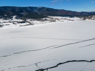 Aerial winter view of Batak Reservoir covered with ice, Bulgaria