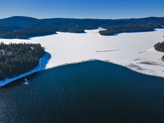 Aerial view of Golyam Beglik Reservoir covered with ice, Bulgaria