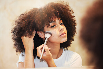 I want to shine as beautiful as the sun today. Shot of a beautiful young woman using a makeup brush...