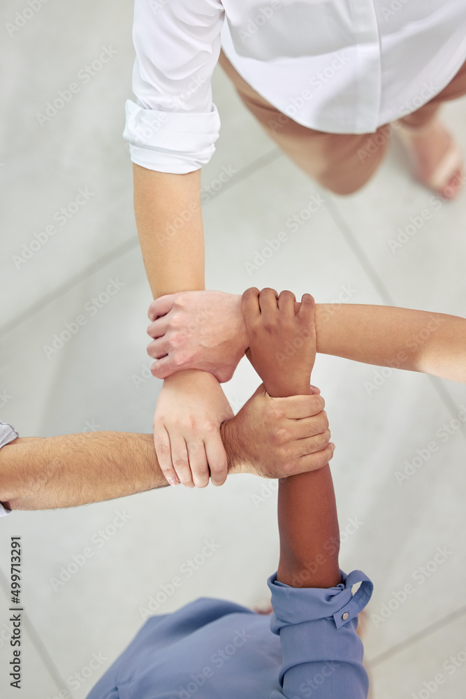 Poster were all connected in some way. high angle shot of a group of unrecognizable businesspeople holding 