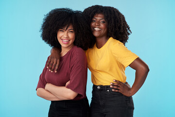 Friends dont let friends stand alone. Studio shot of two young women embracing each other against a...